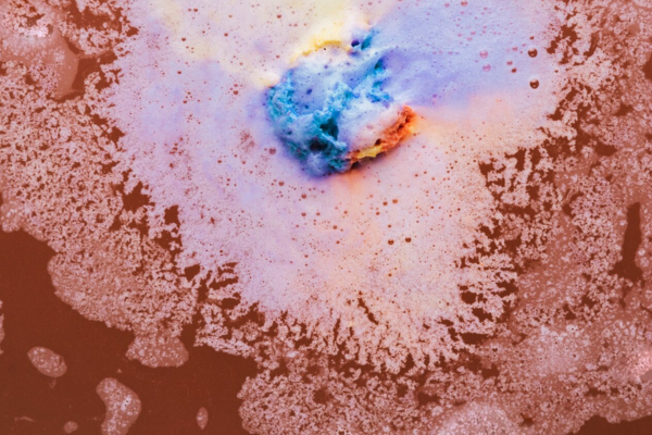 Colorful foam on brown water